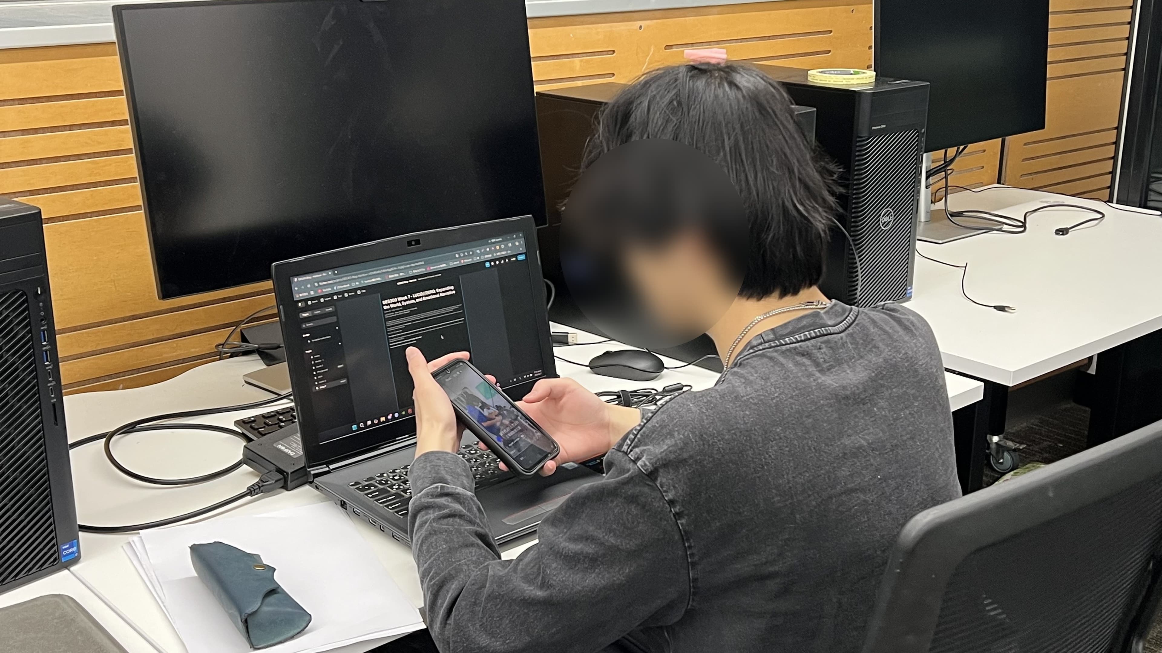 A friend checking a phone during a planned distraction moment in a Focus Integrity test session, with their face blurred for privacy.