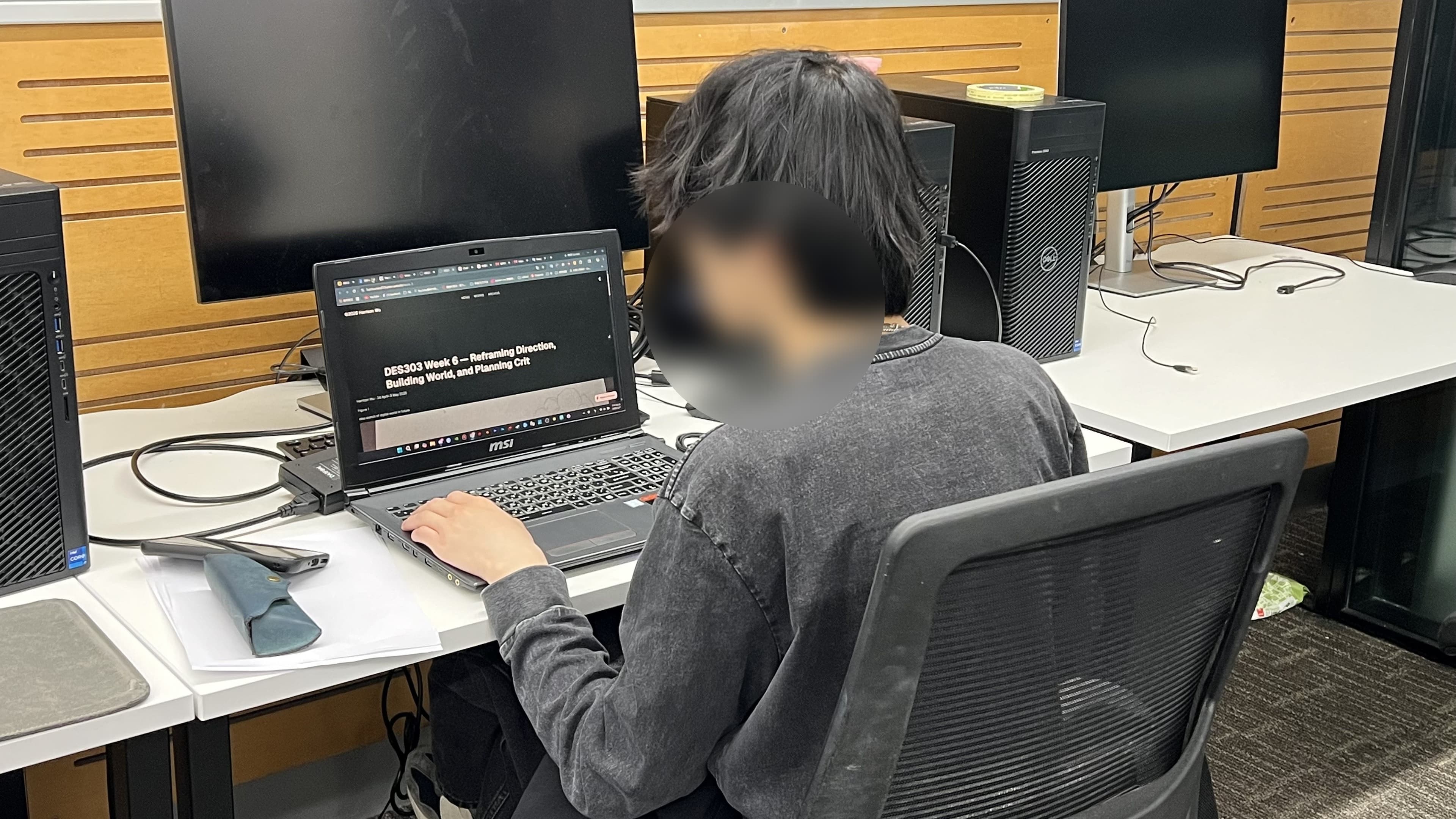 A friend studying at a laptop during a Focus Integrity test session, with their face blurred for privacy.